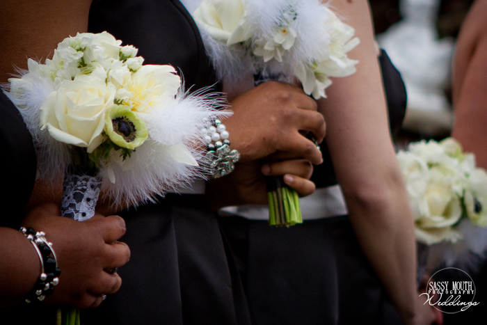 With smaller white feather accented bouquets to compliment the brides 